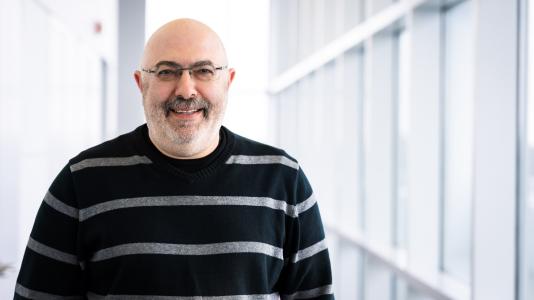 Man wearing glasses smiling.