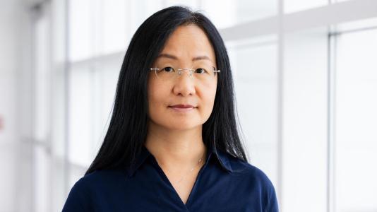 Photo of a woman wearing glasses and a collared blouse.