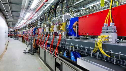 A long row of fully assembled magnets in the APS storage ring tunnel. 