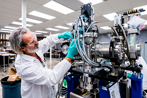 Technician Dino Canchola works on one of the new front-end exit tables that will be installed in the upgraded APS, inside the clean room in the APS Upgrade’s offsite facility. These new front end systems will deliver the brighter X-ray beams to the research stations, and cut off those beams when needed. 