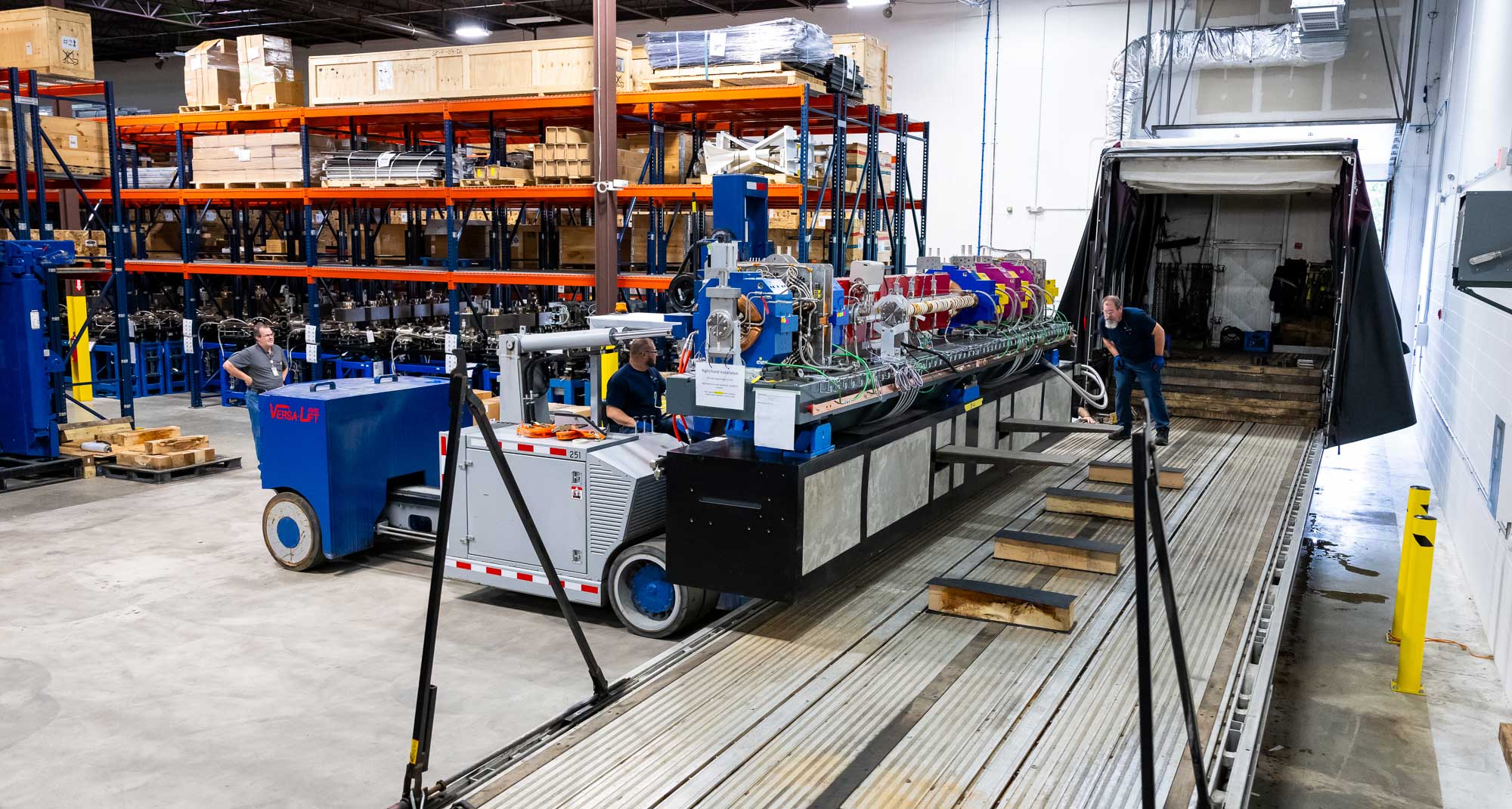 Workers use a specially weighted fork truck to lift the module, which weighs about 25 tons, onto a truck for its brief voyage to the APS facility.