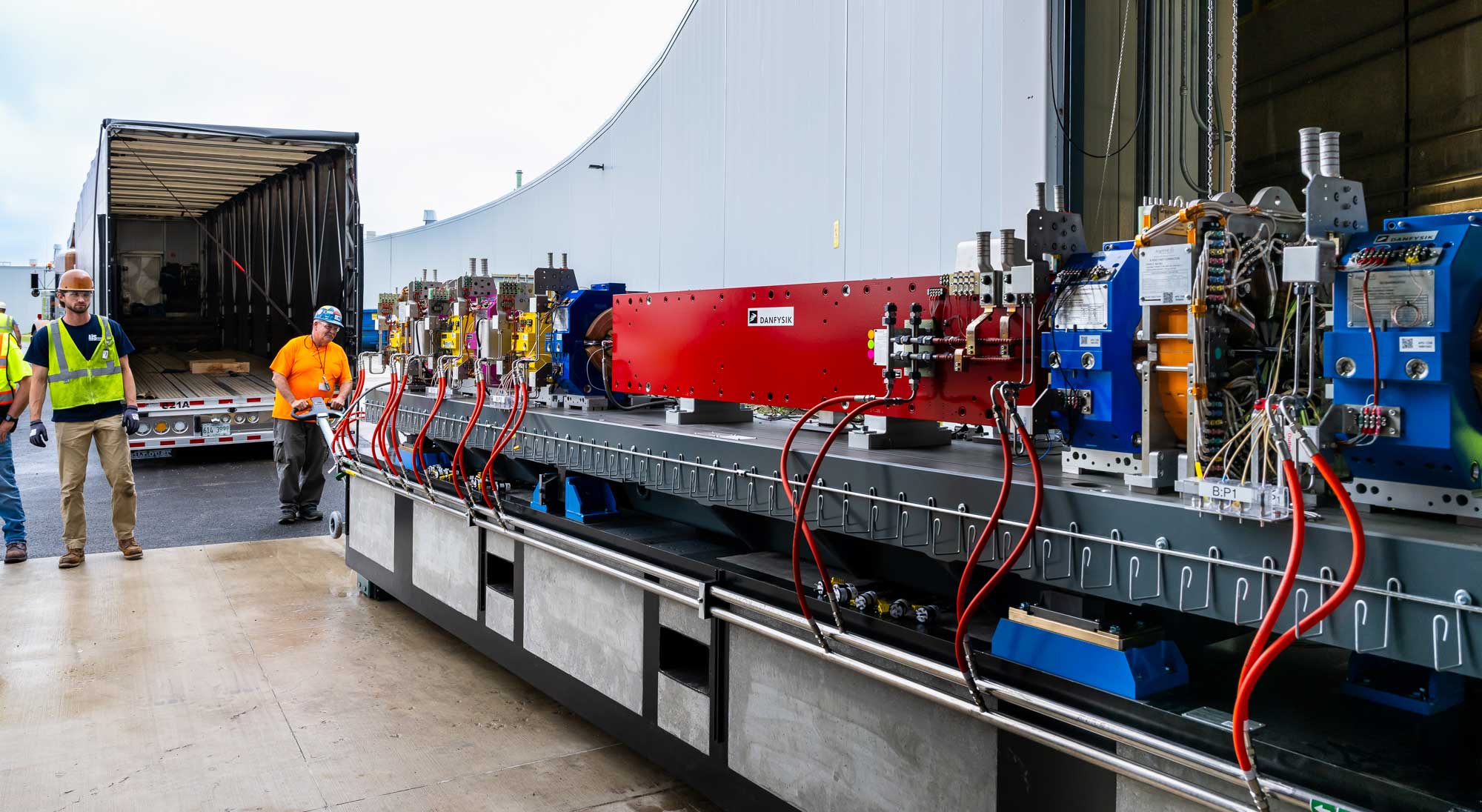 After a forklift is used to remove the module from the truck, workers enlist a specially crafted hydraulic roller, called a “power attack,” to carefully wheel it into the storage ring facility.