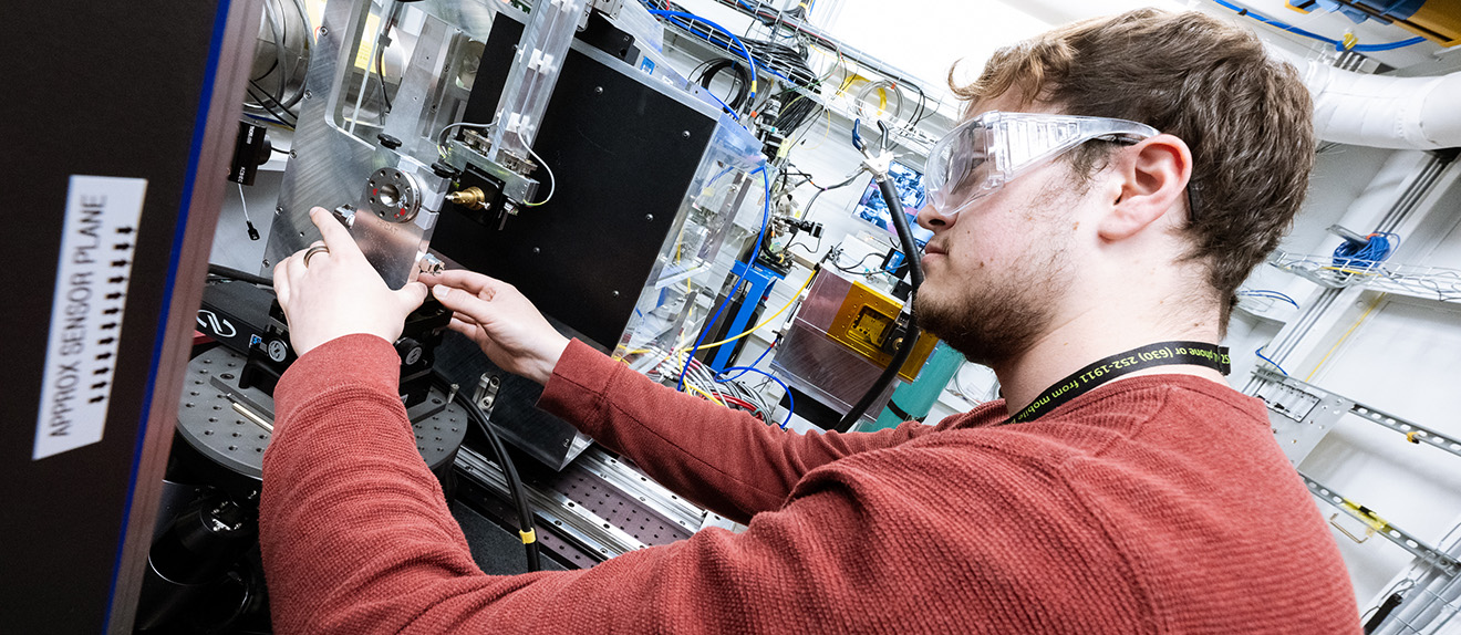 Young man working on a machine.