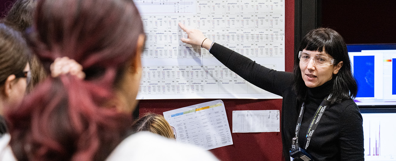 Woman pointing to a board.