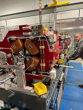 Electromechanical technician Jaroslaw Zygula examines a reassembled magnet with the vacuum system installed. Reassembling the magnets is one of the last major steps before a module goes through the final checks necessary to deem it ready to be installed in the APS storage ring.