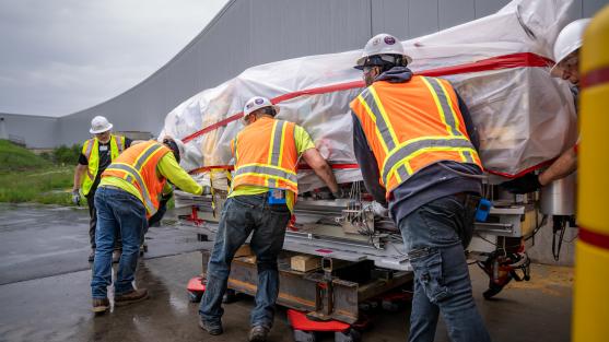 Workers remove the first module of the original APS storage ring