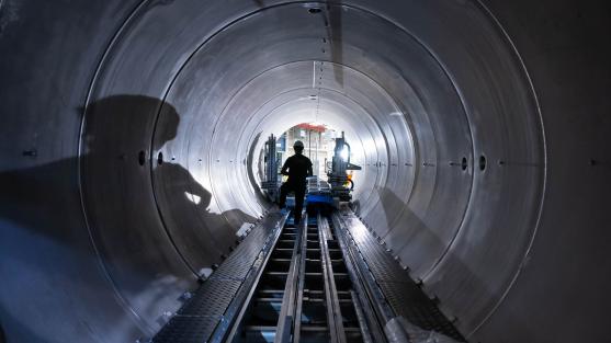 Worker in large metal tube