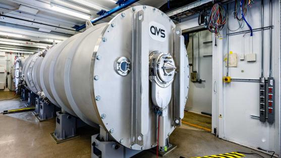 A large silver tube sits in the end station of beamline 12-ID.