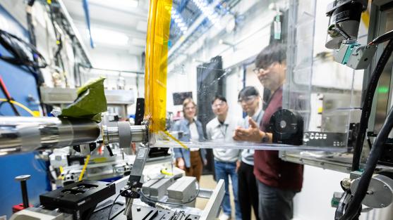 Four scientists looking at a machine.