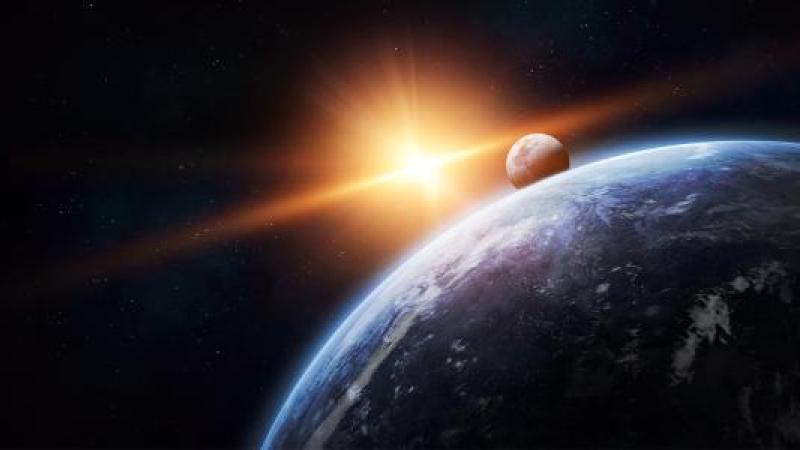 Earth in the foreground with sun and moon behind it in space.