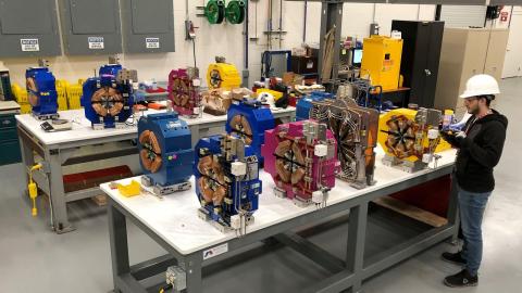 : Newly received magnets are tested before being assembled into modules for the upgraded APS storage ring. 1,321 powerful magnets will be used in the storage ring, and they must each be precisely aligned with each other. (Image by Argonne National Laboratory.)