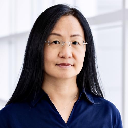 Photo of a woman wearing glasses and a collared blouse.